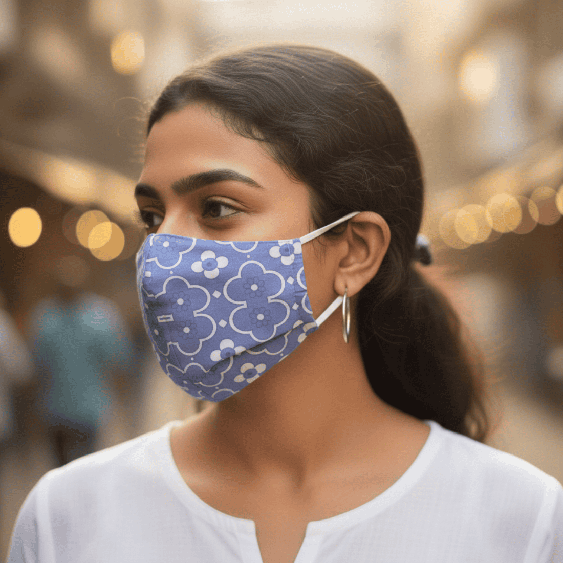 Woman wearing a blue floral-patterned face mask