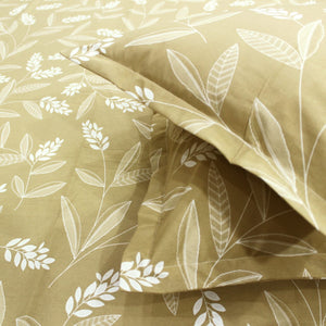 Close-up of a mustard yellow fitted bedsheets with a floral print design.