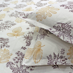 Close-up of a printed floral cotton bedsheet in brown and white colors with a damask design.