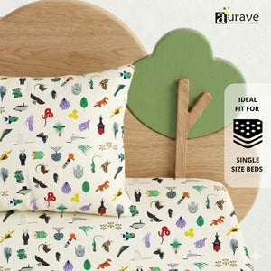 Nature-themed kids pillow with colorful animal prints resting against a wooden tree and cloud headboard, featuring AURAVE premium pure cotton bedding.