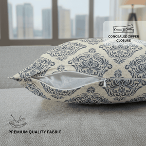 Decorative pillow with pattern on a couch, featuring text about concealed zipper closure and premium quality fabric.