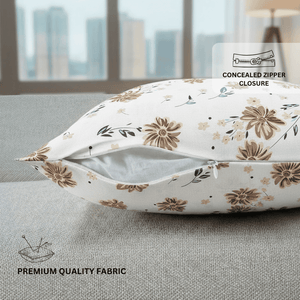 Floral-patterned pillow with concealed zipper closure on a couch.