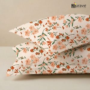 Close-up of AURAVE peach floral print cotton pillow covers stacked neatly