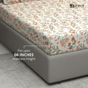 Floral patterned fitted bedsheet on a bed with 'aurave' branding.