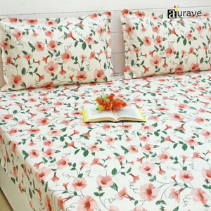 Floral patterned fitted bedsheet set with pillows on a bed, featuring the brand 'aurave'.