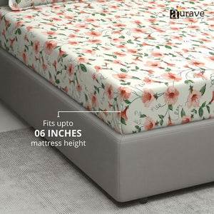 Floral patterned fitted bedsheet on a bed with 'aurave' branding.