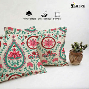 Neatly stacked AURAVE cotton pillow covers showing a traditional Indian block-print design in pink and teal.