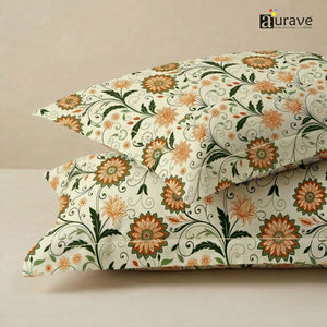 Close-up texture of AURAVE cotton fabric featuring a vibrant orange floral and green vine pattern for pillow covers.