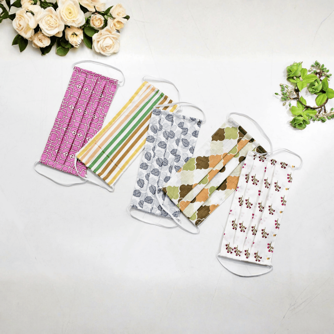 Five fabric face masks with different patterns  