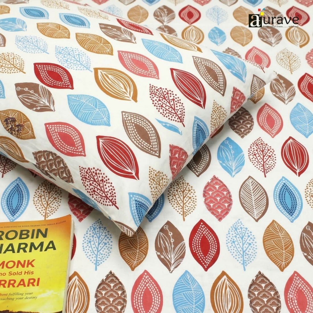 Close-up of 100% cotton bedsheet with leaf print in earthy tones, soft texture and skin-friendly fabric