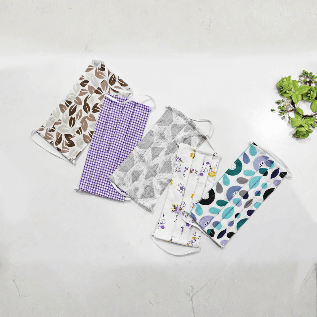 Five fabric face masks with different patterns  
