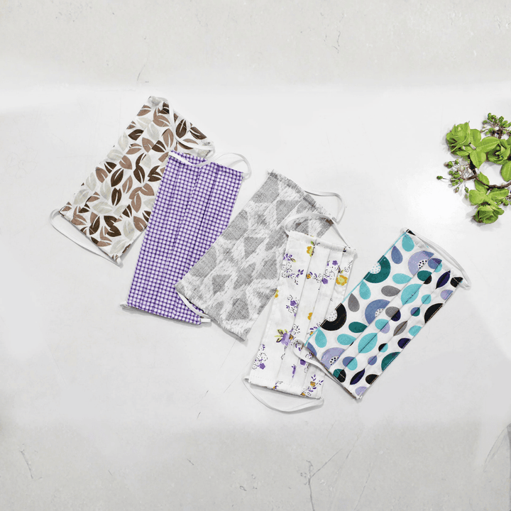 Five fabric face masks with different patterns  