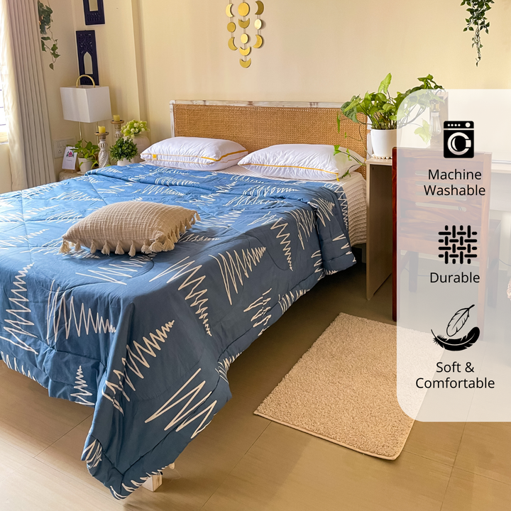 Blue microfiber 150 GSM comforter neatly spread on bed, machine washable, soft, durable, all season quilt