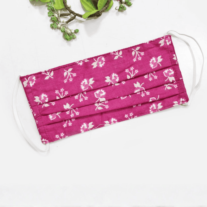 Pink face mask with white floral pattern 
