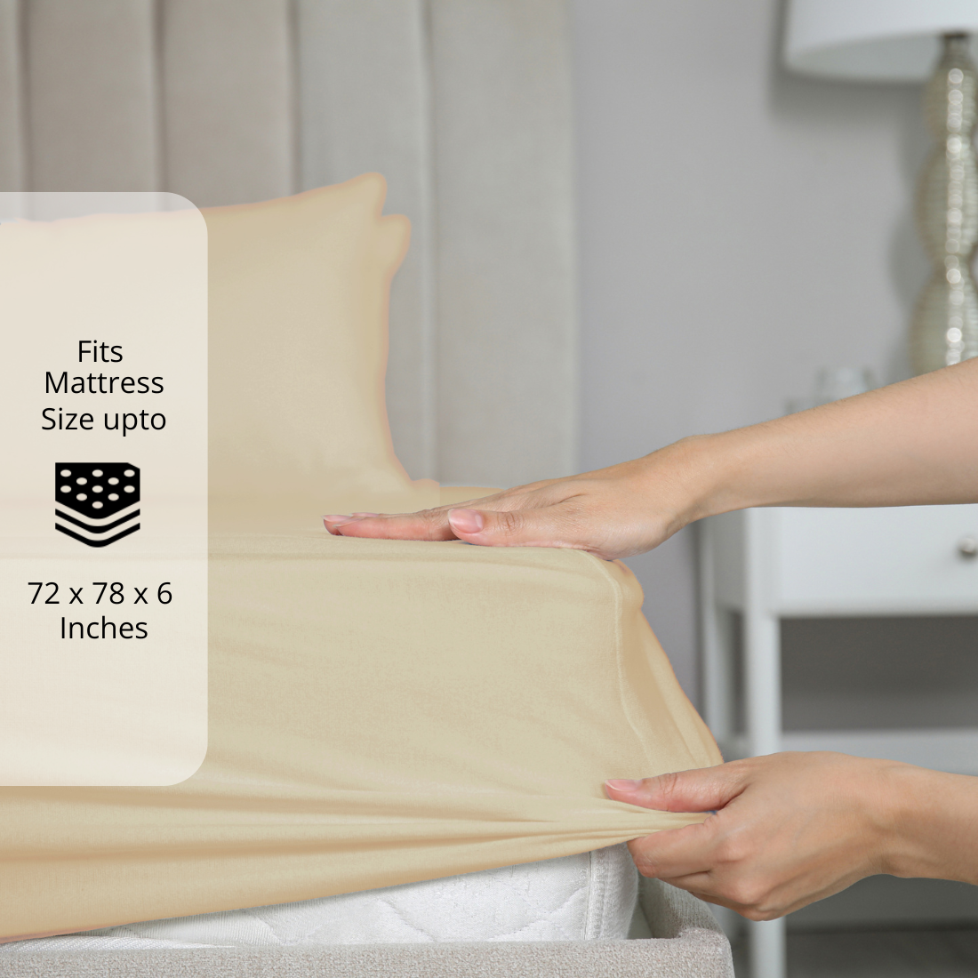 Beige bedsheet being stretched over mattress corner with size label showing fits mattress size up to 72 x 78 x 6 inches.  