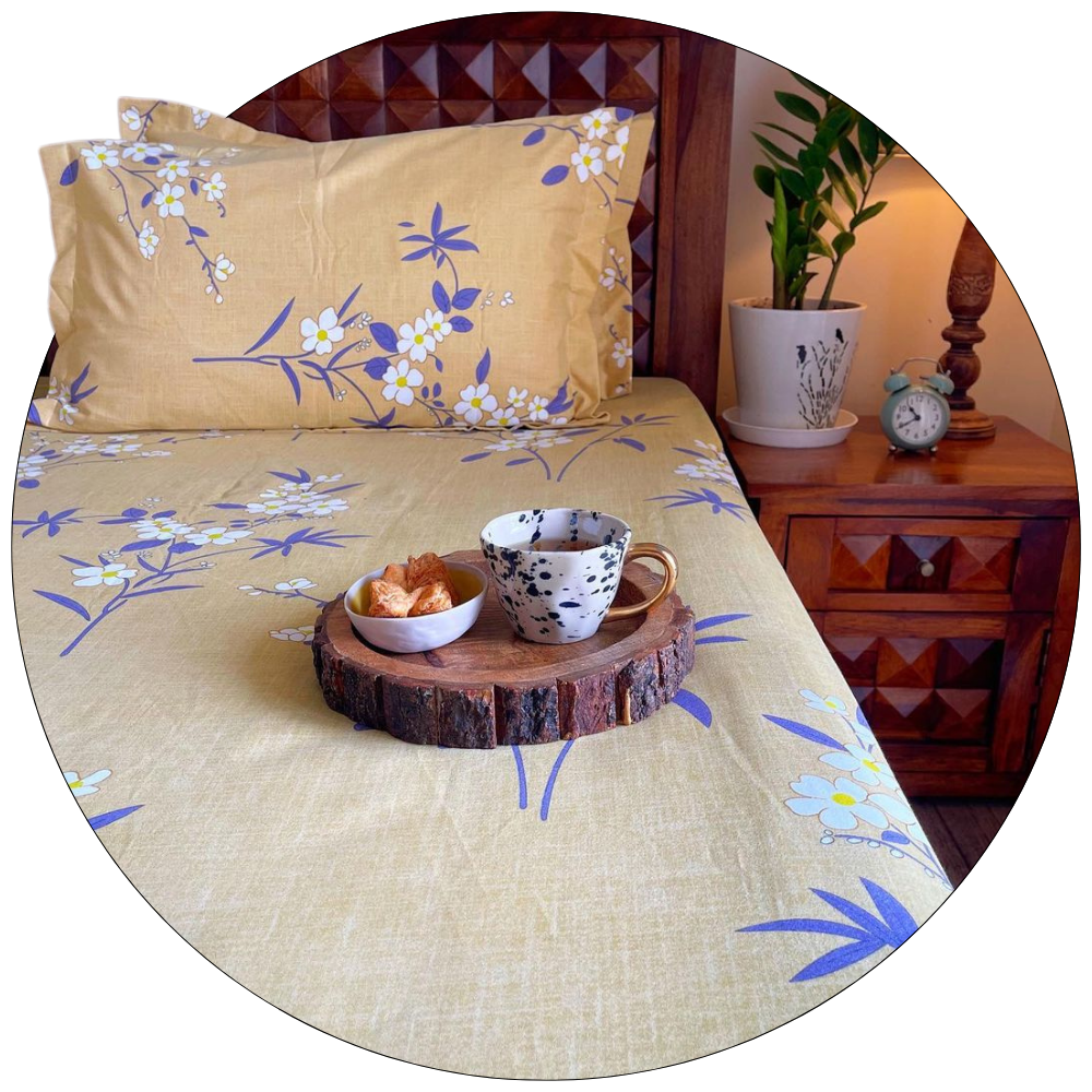 Floral fitted bedsheet set with pillow covers on a neatly made bed – premium cotton bedding for modern bedrooms.