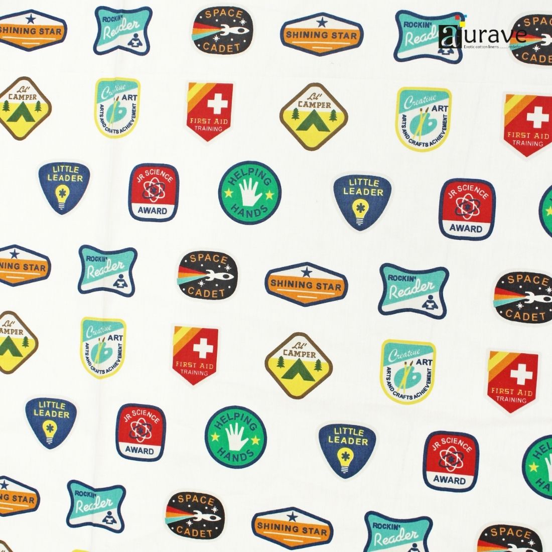 Detailed fabric texture of AURAVE pure cotton kids bedsheet showing colorful printed merit badges like Space Cadet and Shining Star on a white base.