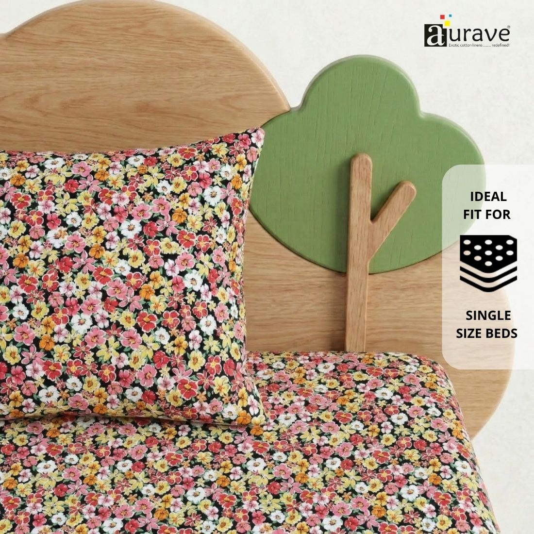 Bright floral patterned pure cotton kids pillow resting against a wooden tree and cloud headboard by AURAVE.