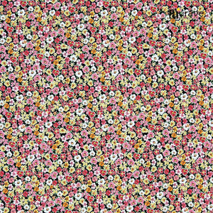 Fabric texture close-up showing a dense pattern of red, pink, yellow, and white flowers on a dark cotton bedsheet.