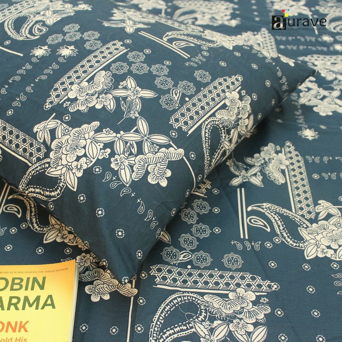 Close-up of 210 TC pure cotton kids pillowcase and bedsheet in dark teal blue with white patterns, styled with a reading book.