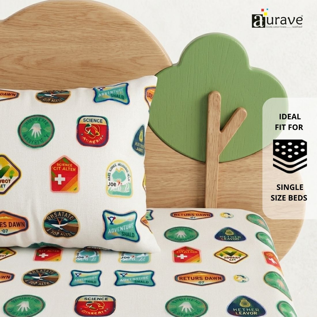 Fun kids pillow with colorful printed merit badges resting against a wooden tree and cloud headboard, featuring AURAVE pure cotton bedding.