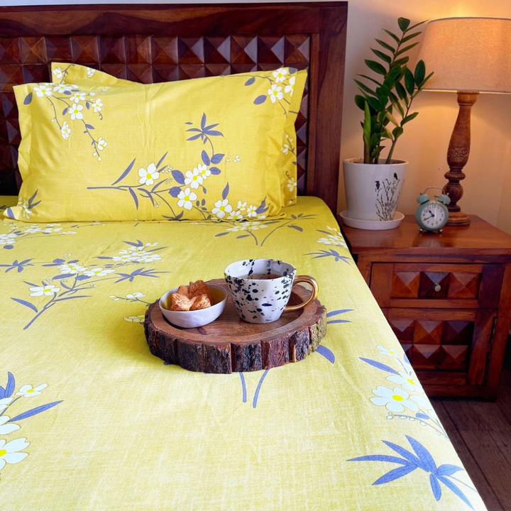 Floral 210 TC olive fitted bedsheet with matching pillow covers styled in a bright bedroom.