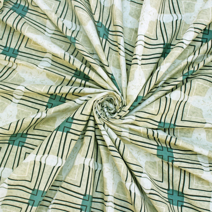 Cotton blend bedsheet fabric with green and beige geometric print, swirl folded close-up