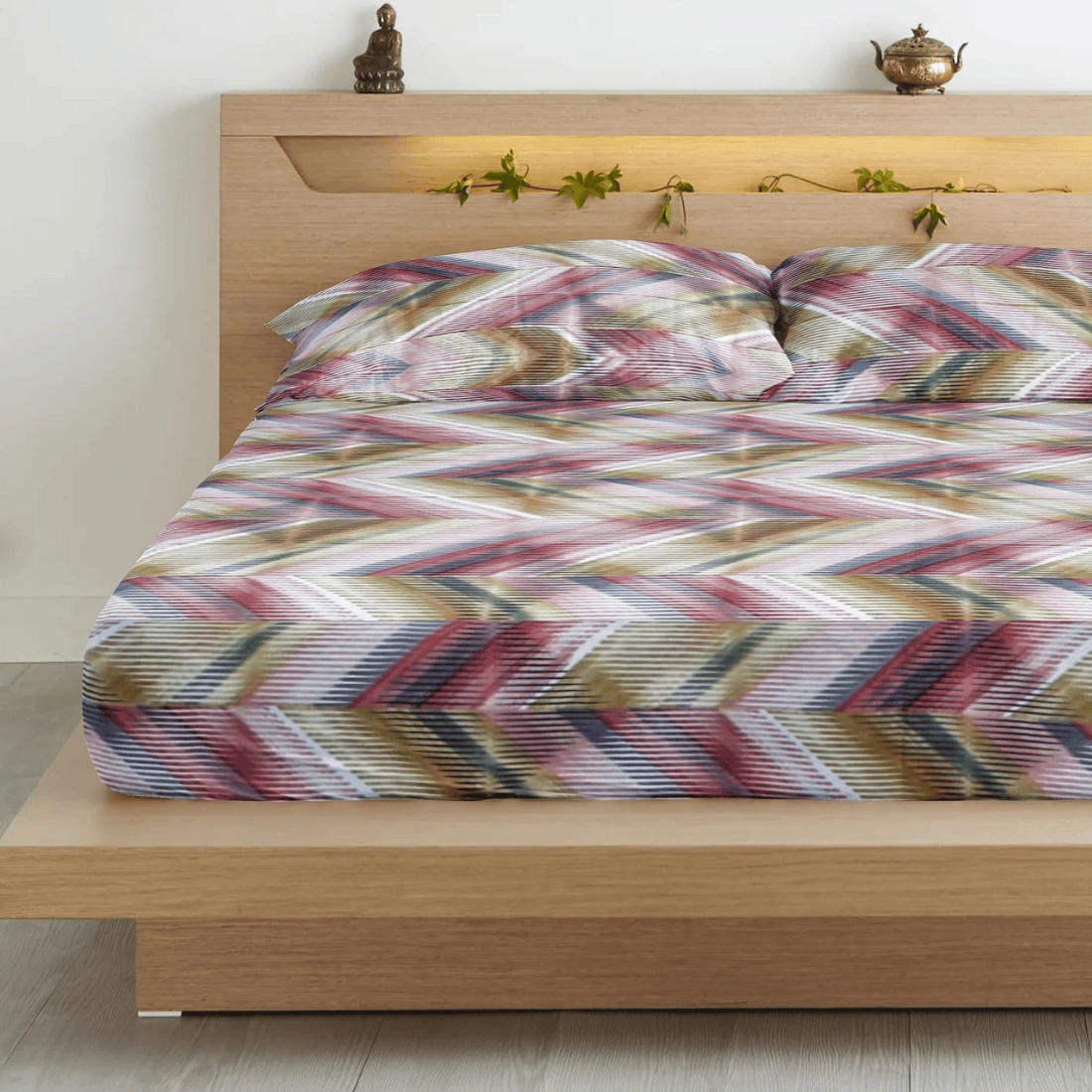 Multicolor geometric patterned king-size flat bedsheets with pillow covers, displayed on a bed.