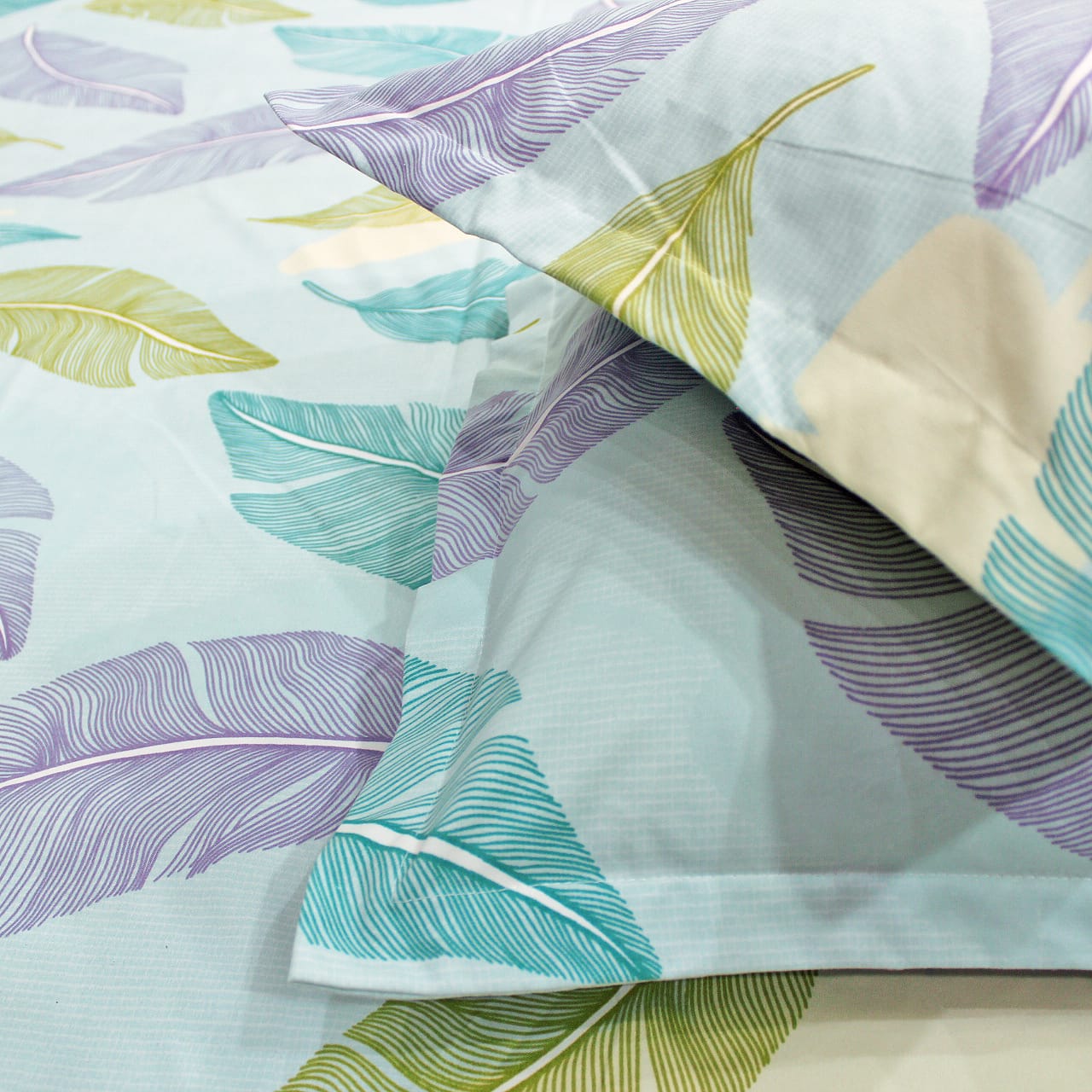 cotton flat bedsheet with matching pillow covers.