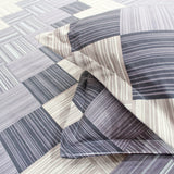 A fitted bedsheets set with a geometric pattern in purple 