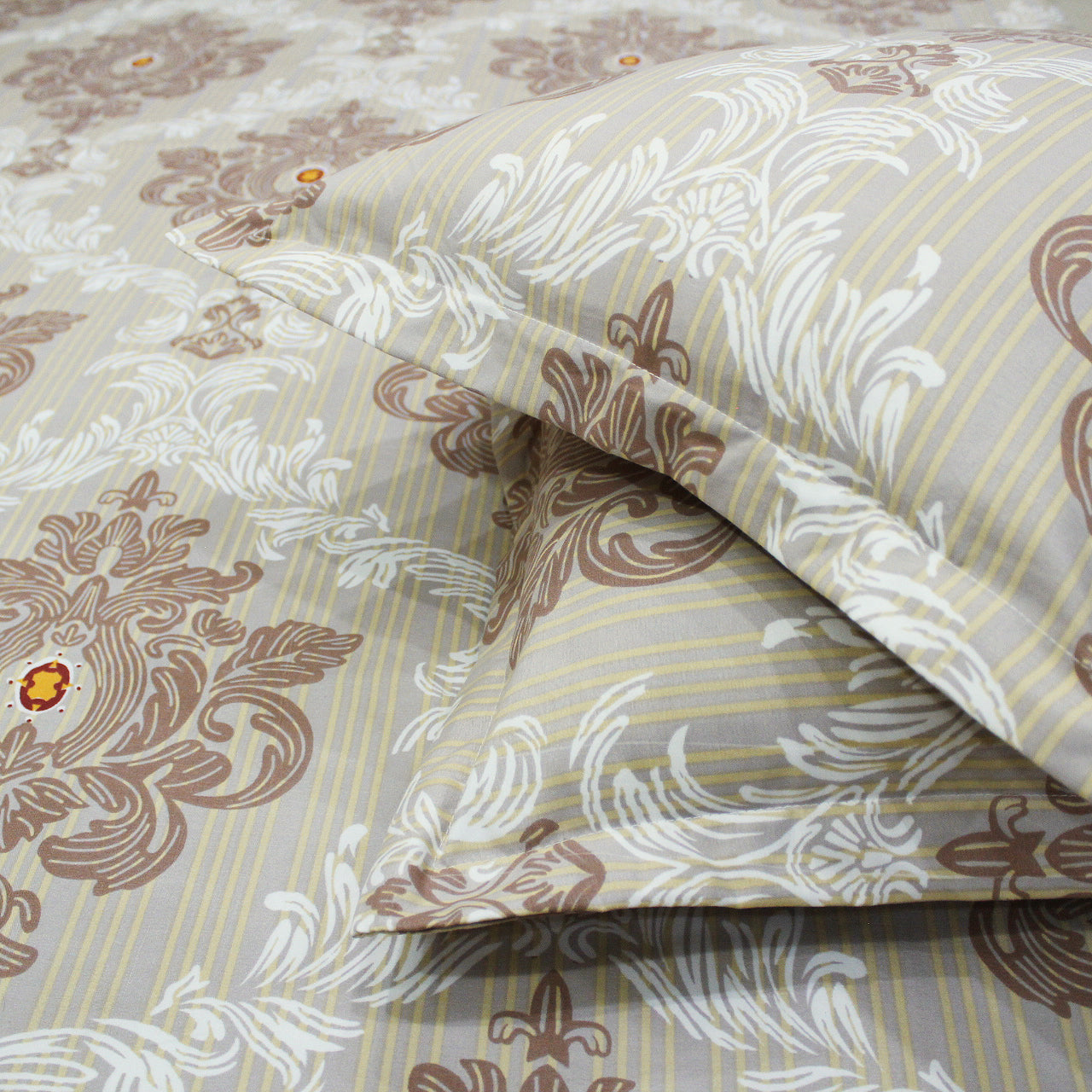 fitted bedsheets with pillow covers featuring a damask design in khaki color.