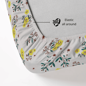 Floral patterned fitted Bedsheet with elastic all around on a mattress.