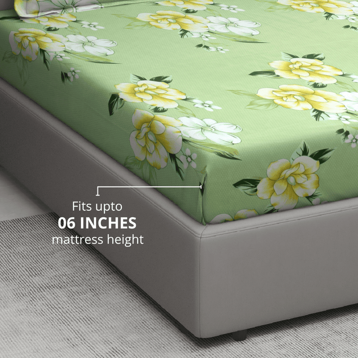 Floral patterned mattress cover on a bed with text indicating mattress height compatibility.