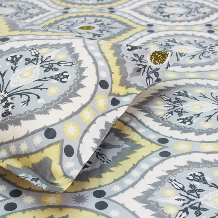 Cotton blend double bedsheet with blue and yellow floral print and matching pillow cover, close-up view
