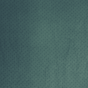 Teal green patterned cotton fabric close-up