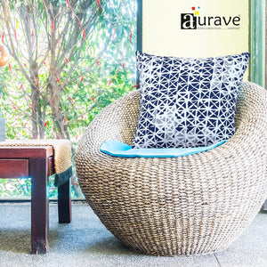 Aurave geometric blue cotton cushion cover displayed on woven chair
