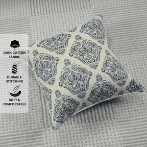 Decorative pillow with blue pattern on a textured gray surface, featuring text labels about fabric and comfort.