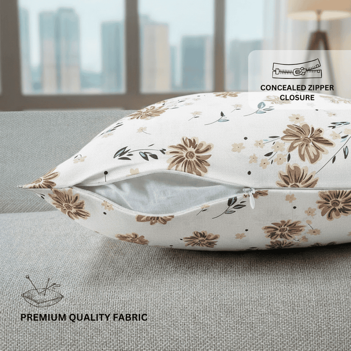 Floral-patterned pillow with concealed zipper closure on a couch.