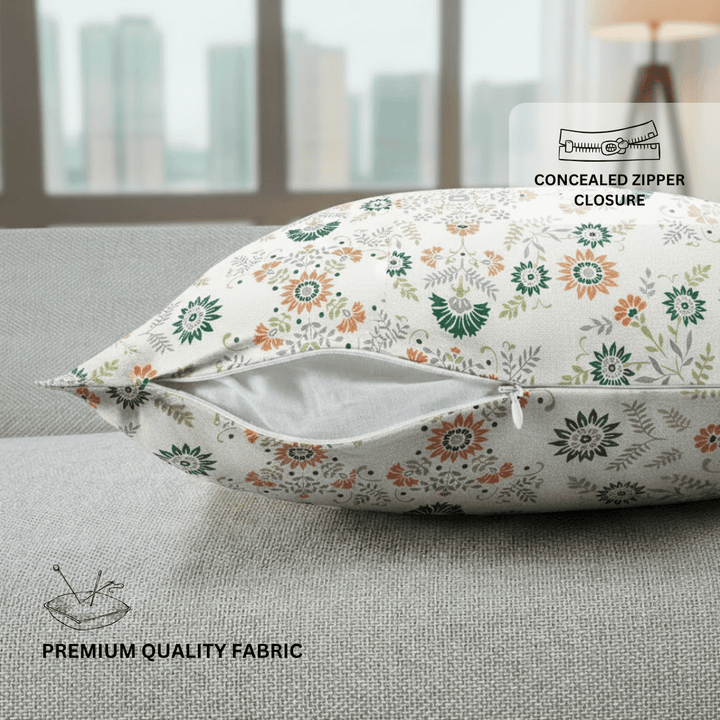 Floral-patterned pillow on a couch with text indicating concealed zipper closure and premium quality fabric.