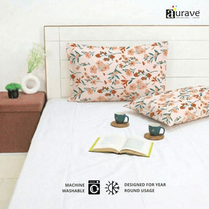 Machine washable AURAVE floral pillow covers styled on a bed with a white sheet, coffee cups, and a book for year-round usage.