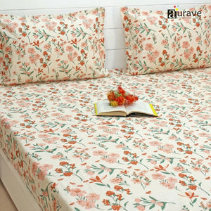 Floral patterned bedsheet with matching pillows on a bed, branded 'aurave'.
