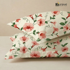 Close-up texture of AURAVE cotton fabric featuring a large pink floral and green vine print for pillow covers.