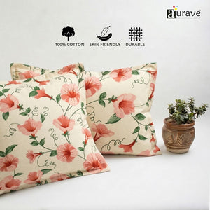 Neatly stacked AURAVE cotton pillow covers showcasing a vibrant pink floral and vine design.