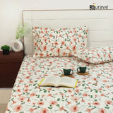 Floral patterned fitted bedsheet set with pillows on a bed, featuring the brand 'aurave'.