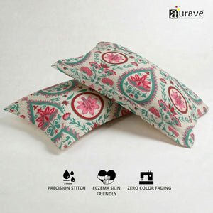 100% cotton, skin-friendly, and durable AURAVE pillow covers with pink lotus motifs displayed next to a small potted plant.