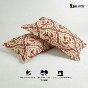 100% cotton, skin-friendly AURAVE pillow covers with a maroon block-print design, displayed upright next to a small indoor plant.
