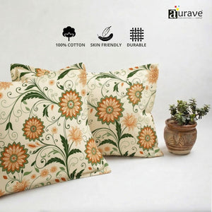 Neatly stacked AURAVE cotton pillow covers showcasing a beautiful orange flower and green leaf trailing vine design.