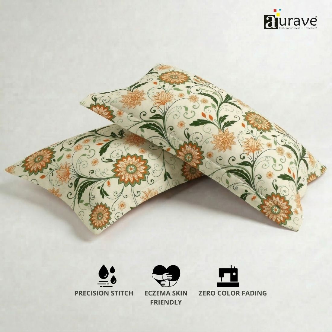 100% cotton, skin-friendly, and durable AURAVE pillow covers with an orange floral print, displayed next to a small potted plant.
